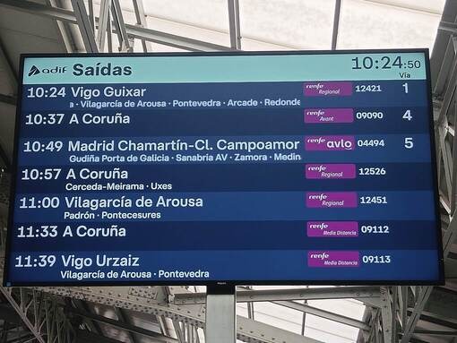 サンティアゴ駅の青い電光掲示板。AVLOの出発時刻とホーム番号が表示されている。