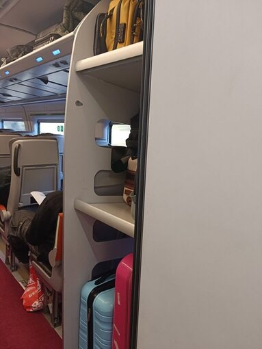 AVLO車内の3段式荷物棚にスーツケースが収納されている様子。